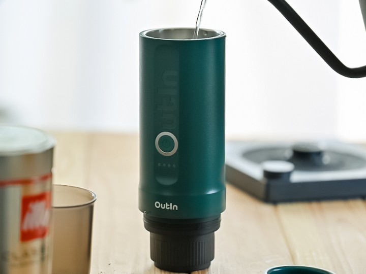 Water being poured into the OutIn Nano Teal. Coffee in foreground