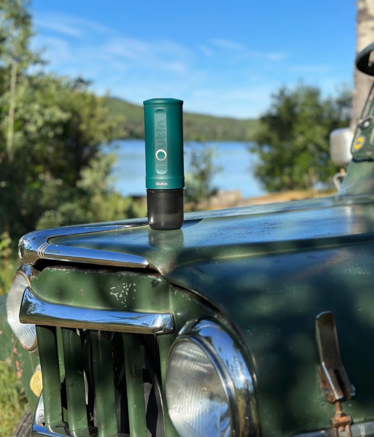 OutIn Teal Nano on the hood of a car outdoors